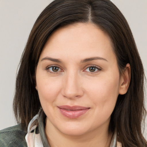 Joyful white young-adult female with medium  brown hair and brown eyes