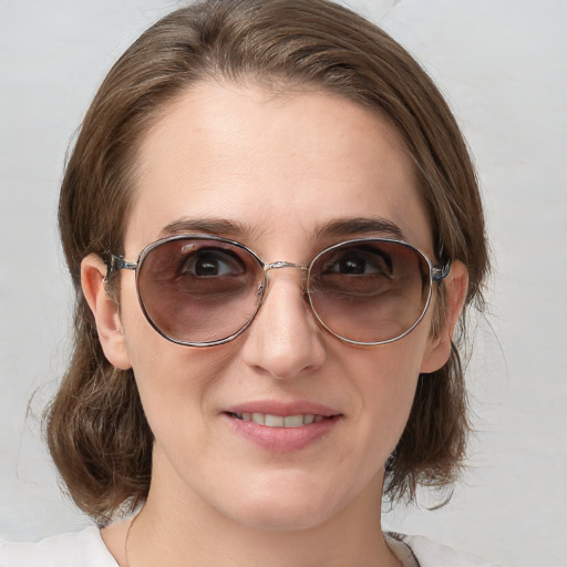 Joyful white adult female with medium  brown hair and blue eyes