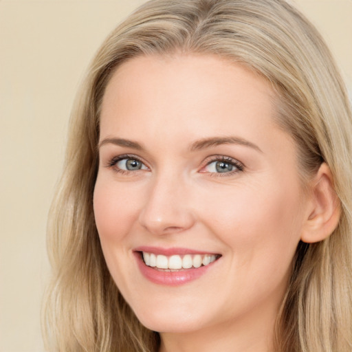 Joyful white young-adult female with long  brown hair and blue eyes