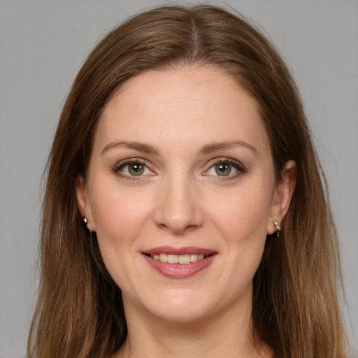 Joyful white young-adult female with long  brown hair and green eyes