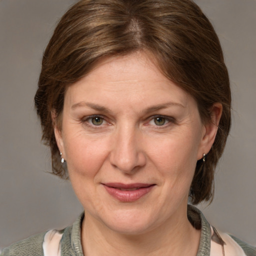 Joyful white adult female with medium  brown hair and grey eyes