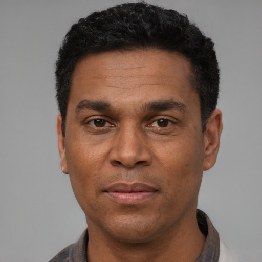 Joyful white adult male with short  black hair and brown eyes