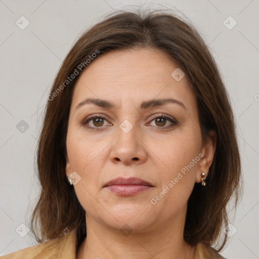 Joyful white adult female with medium  brown hair and brown eyes