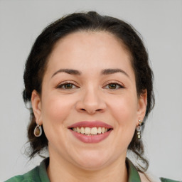 Joyful white young-adult female with medium  brown hair and green eyes