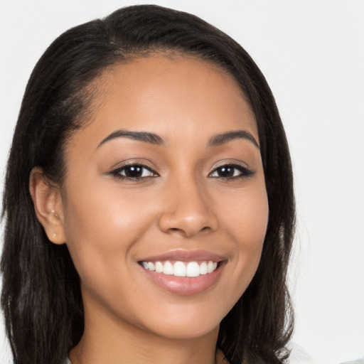 Joyful latino young-adult female with long  brown hair and brown eyes