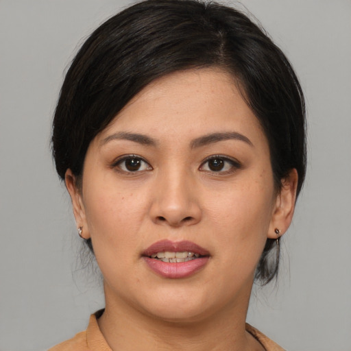 Joyful asian young-adult female with medium  black hair and brown eyes