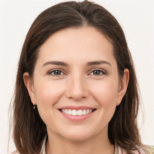 Joyful white young-adult female with long  brown hair and grey eyes