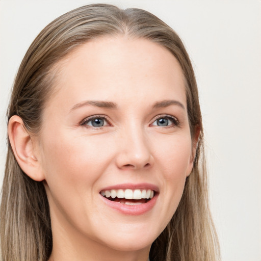 Joyful white young-adult female with long  brown hair and grey eyes