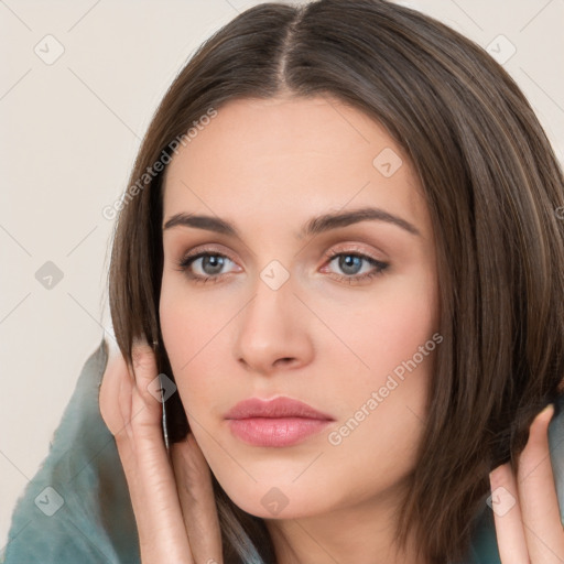 Neutral white young-adult female with long  brown hair and brown eyes