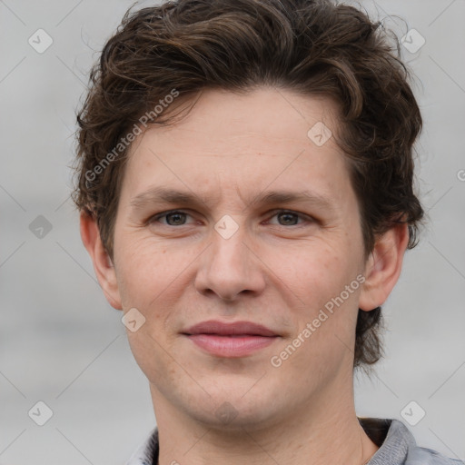 Joyful white adult male with short  brown hair and grey eyes