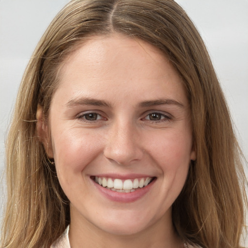 Joyful white young-adult female with long  brown hair and grey eyes