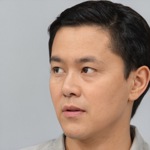 Neutral asian young-adult male with short  black hair and brown eyes