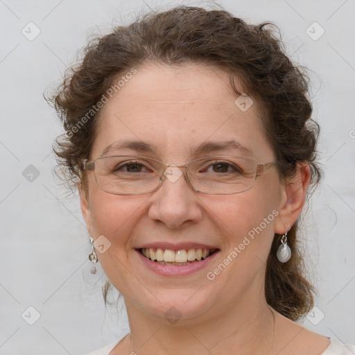 Joyful white adult female with medium  brown hair and blue eyes