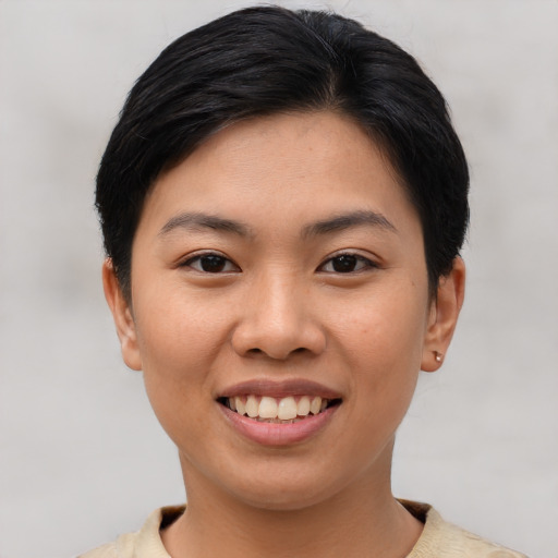 Joyful asian young-adult female with short  brown hair and brown eyes