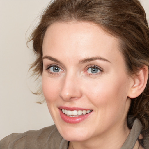 Joyful white young-adult female with medium  brown hair and blue eyes