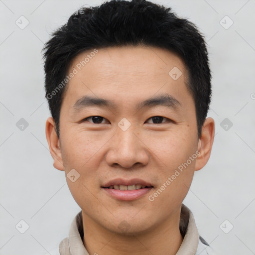 Joyful asian young-adult male with short  black hair and brown eyes