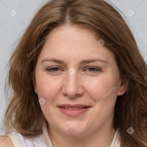 Joyful white adult female with medium  brown hair and blue eyes