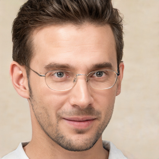 Joyful white young-adult male with short  brown hair and grey eyes