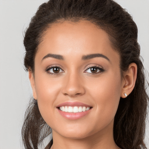 Joyful white young-adult female with long  brown hair and brown eyes