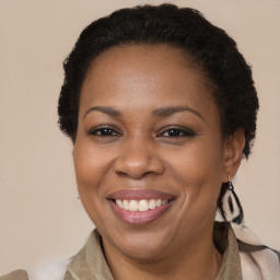 Joyful black adult female with short  brown hair and brown eyes