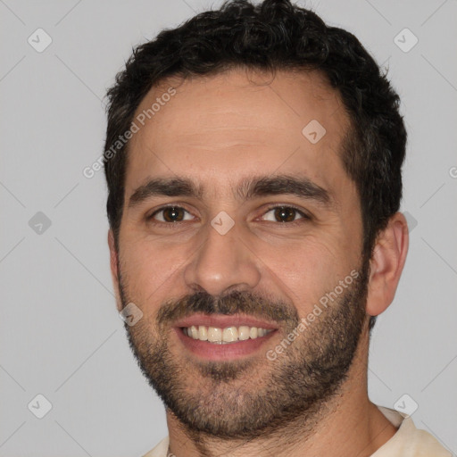 Joyful white young-adult male with short  black hair and brown eyes