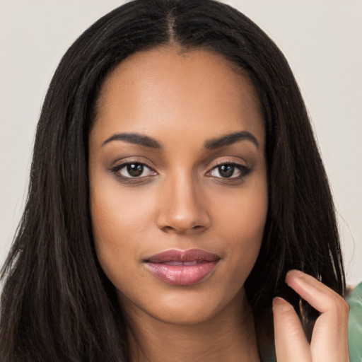 Joyful latino young-adult female with long  black hair and brown eyes