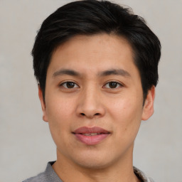 Joyful asian young-adult male with short  brown hair and brown eyes