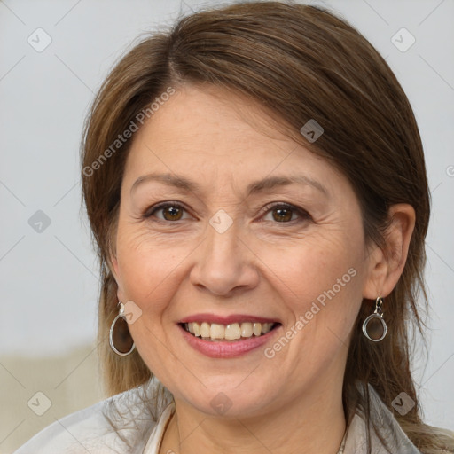 Joyful white adult female with medium  brown hair and brown eyes