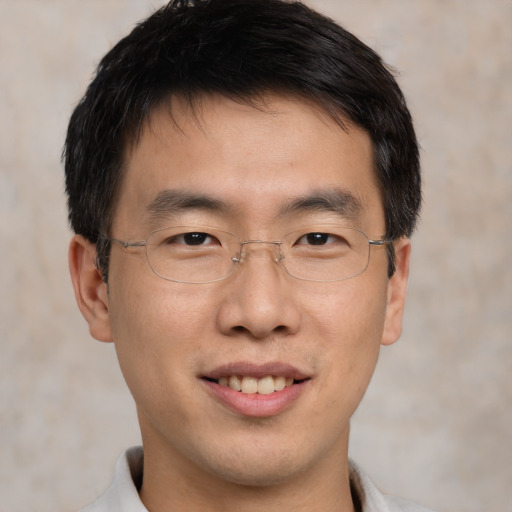 Joyful asian young-adult male with short  brown hair and brown eyes