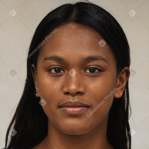 Joyful black young-adult female with long  black hair and brown eyes