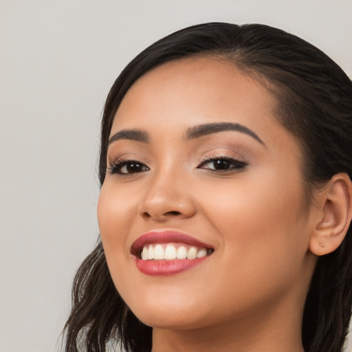 Joyful white young-adult female with long  black hair and brown eyes