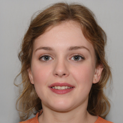 Joyful white young-adult female with medium  brown hair and blue eyes