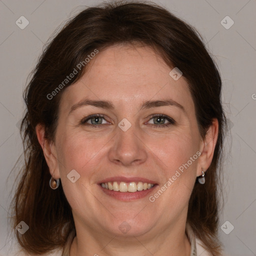 Joyful white adult female with medium  brown hair and grey eyes