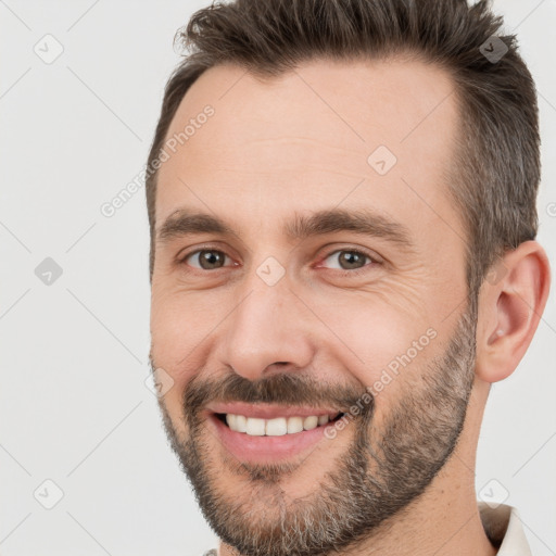 Joyful white adult male with short  brown hair and brown eyes