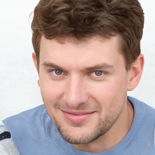 Joyful white young-adult male with short  brown hair and blue eyes