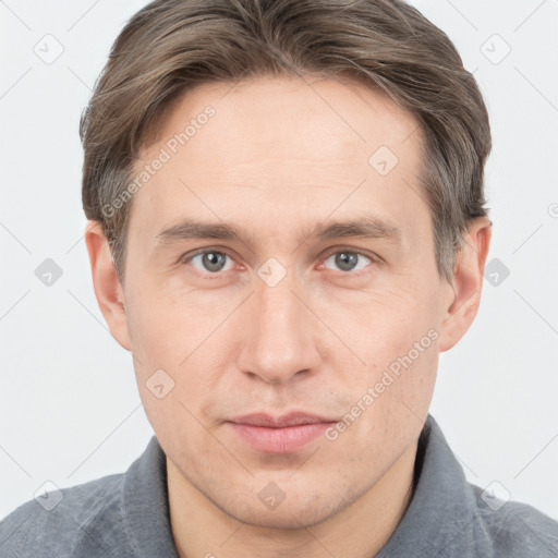 Joyful white adult male with short  brown hair and grey eyes