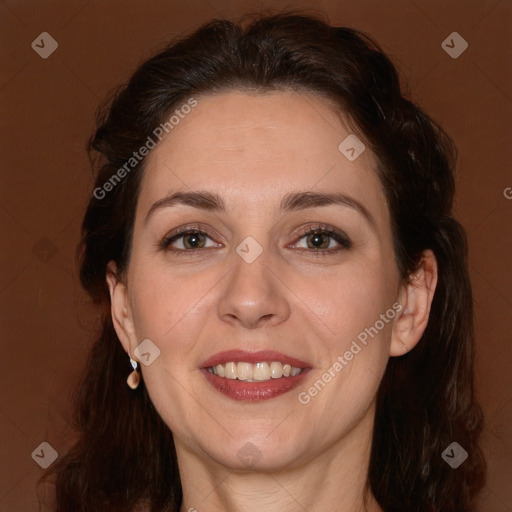 Joyful white adult female with long  brown hair and brown eyes