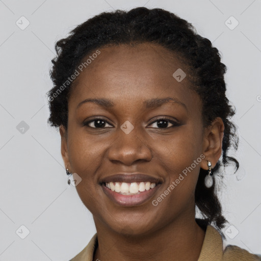 Joyful black young-adult female with long  brown hair and brown eyes