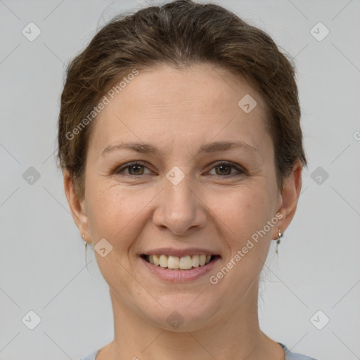 Joyful white adult female with short  brown hair and grey eyes