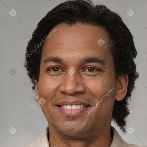 Joyful black adult male with short  brown hair and brown eyes