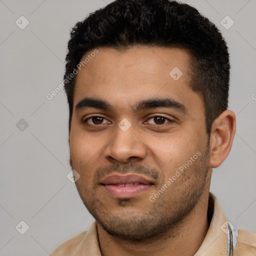 Joyful latino young-adult male with short  black hair and brown eyes