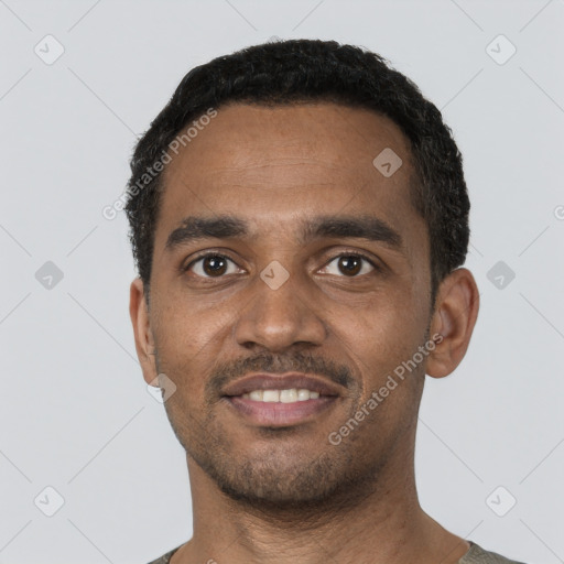 Joyful black young-adult male with short  black hair and brown eyes