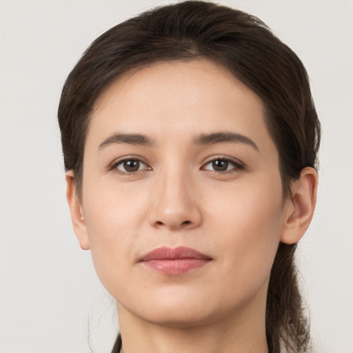 Joyful white young-adult female with long  brown hair and brown eyes