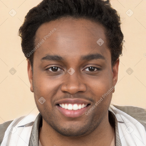 Joyful black young-adult male with short  brown hair and brown eyes