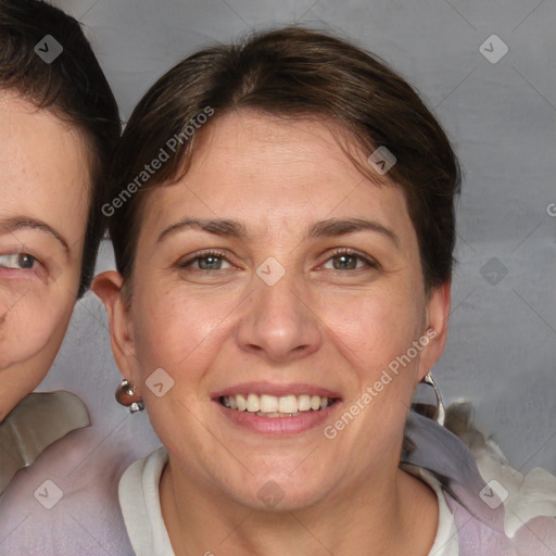 Joyful white adult female with short  brown hair and blue eyes