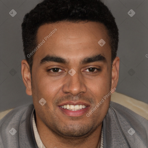 Joyful black young-adult male with short  brown hair and brown eyes