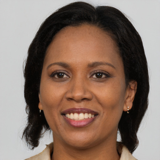 Joyful latino adult female with long  brown hair and brown eyes