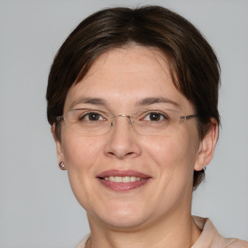 Joyful white adult female with medium  brown hair and brown eyes