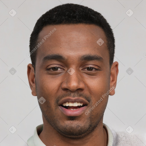 Joyful black young-adult male with short  black hair and brown eyes