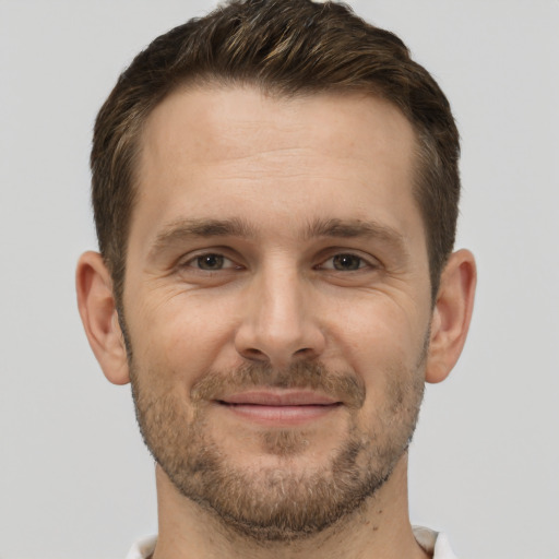 Joyful white adult male with short  brown hair and brown eyes